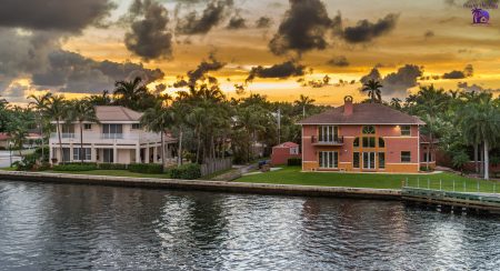 image of two waterfront homes with sunset in the background showing south tampa real estate and south tampa waterfront homes for sale