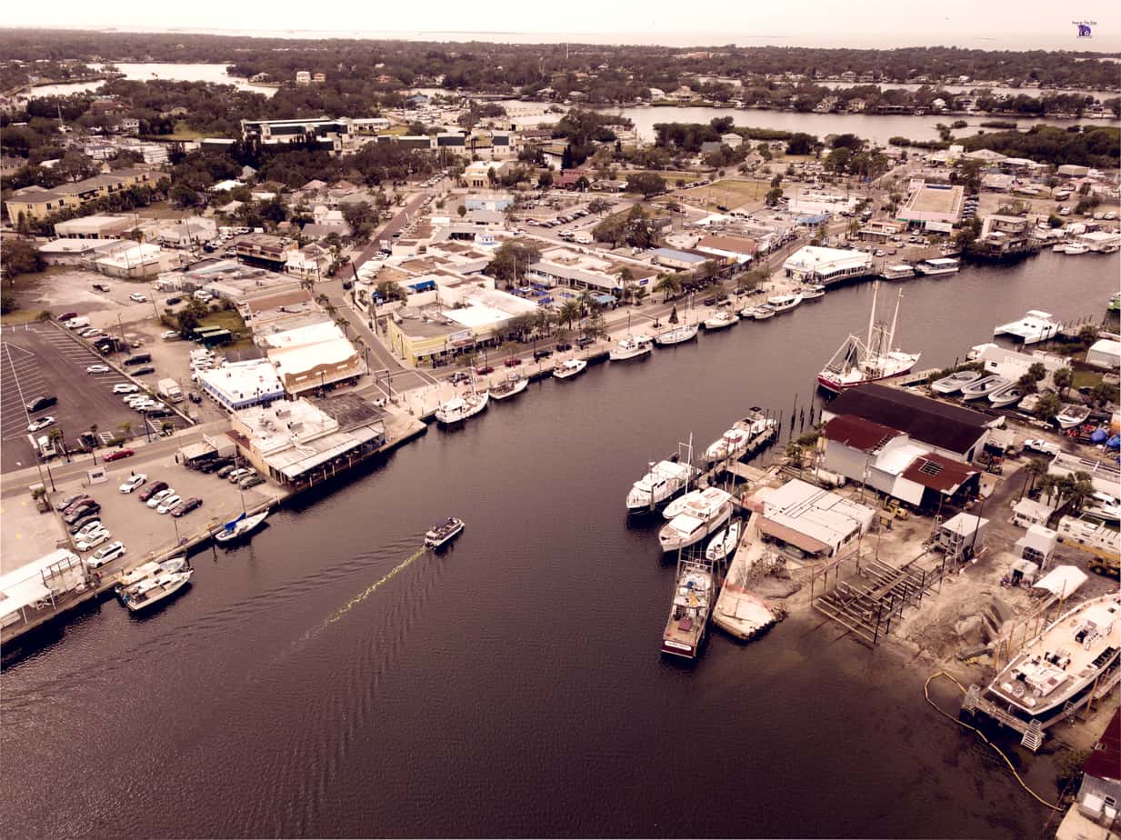 Picture of Downtown Tarpon Springs Sponge Docks in florida with Ariel view of water, boats, and businesses