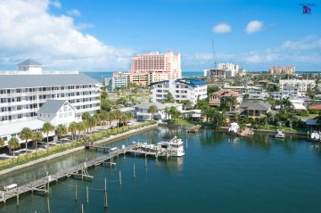 Picture of a waterview of clearwater beach florida with boats, hotels, a pool, and restaurants